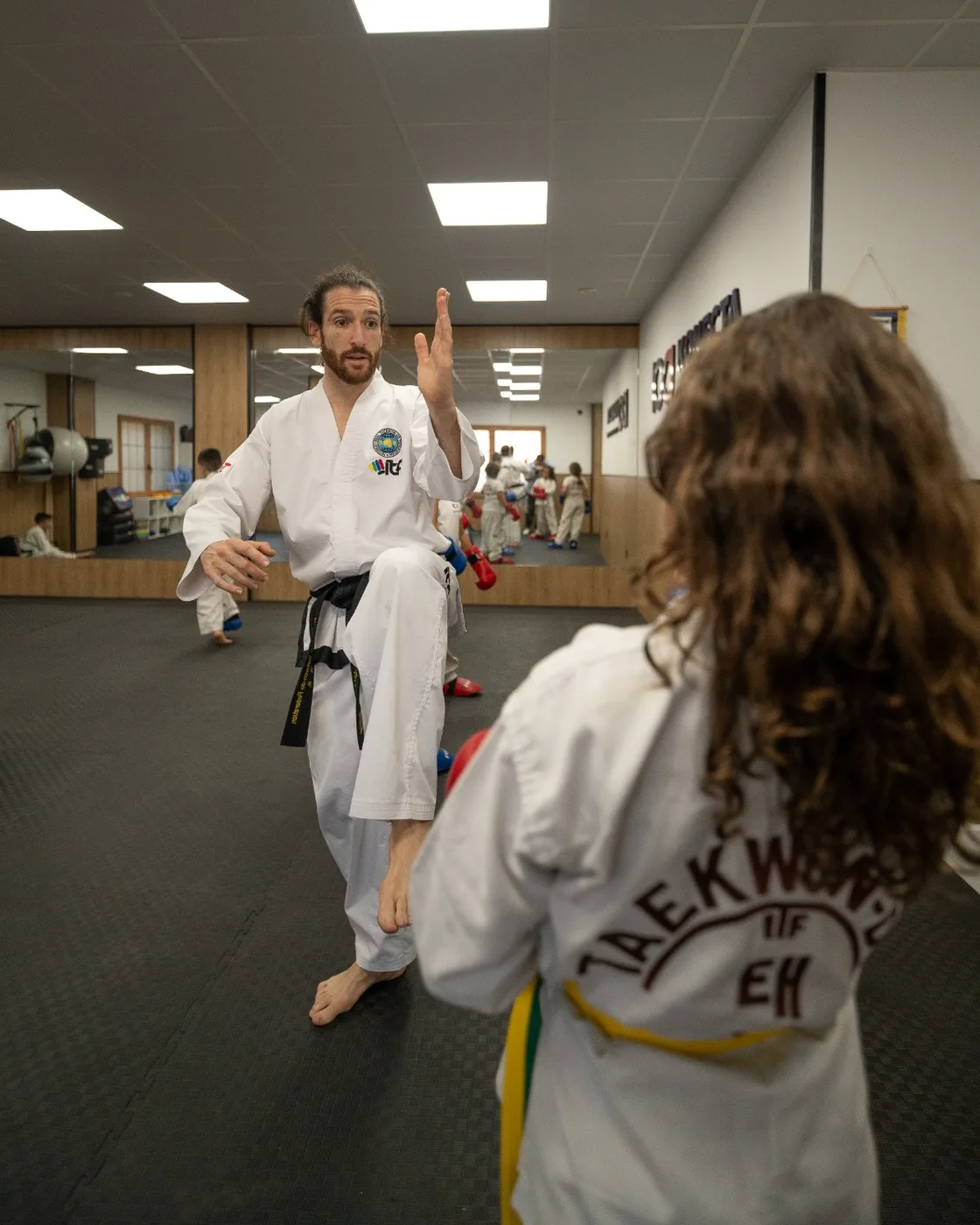 Jaime Vílchez corrigiendo la guardia de una alumna durante una clase de Taekwondo ITF en la sala de Konecta Academy